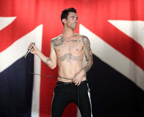 Adam Levine standing in front of a Union Jack flag